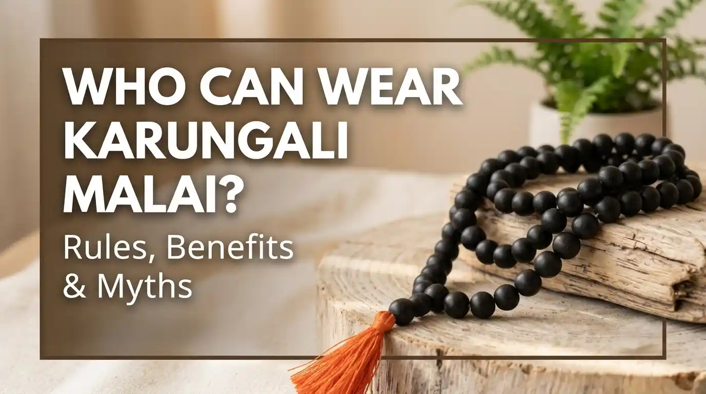 Hand holding an authentic 108 bead Karungali Malai made from natural ebony wood.